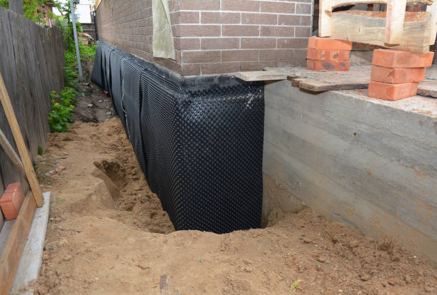 Happy homeowners after waterproofing job in Elmore